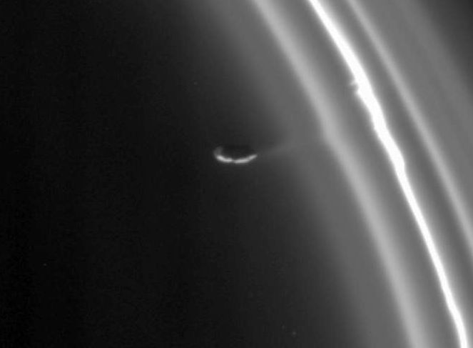 Saturn's moon Prometheus interacting with material in one of Saturn's rings explained in text above