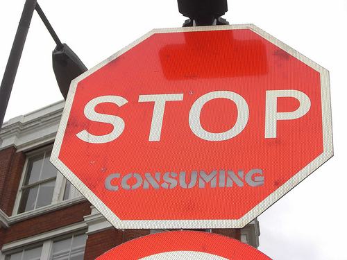 Stop sign with "Stop Consuming" message