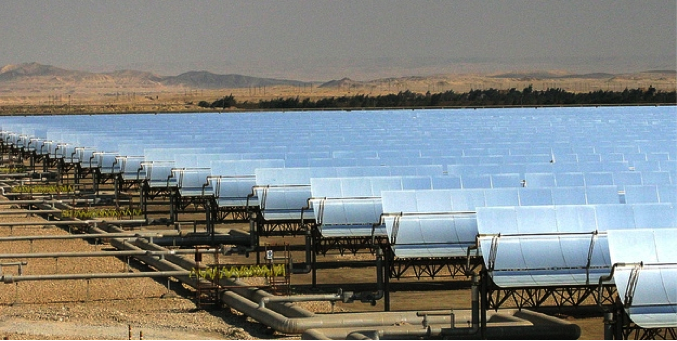 Rows and rows of solar cells in a desert area. See caption for more