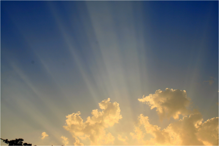 cloud on blue sky with sunlit rays