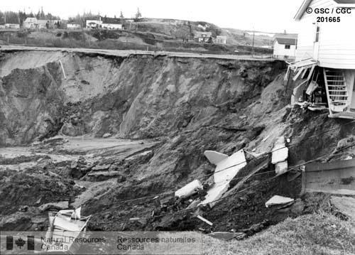 house sitting on edge of crater caused by a landslide