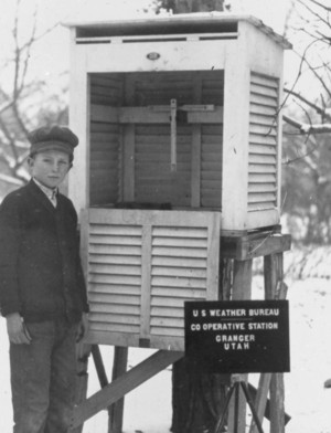 Young child standing next to an instrument shelter