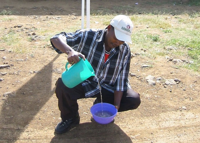 A local Kenyan man demonstrates (wrongly) how water draining out of a bowl is affected by the Coriolis force.